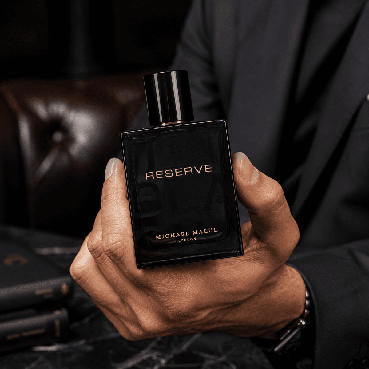 Michael Malul Jet Black Reserve men's perfume in a bold amber woody fragrance setting