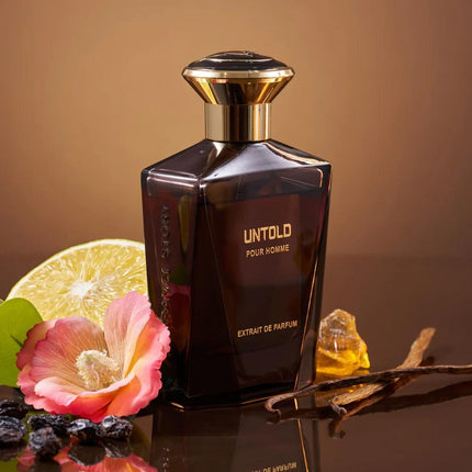Perfume bottle labeled 'Untold' with flowers and fruit on a reflective surface