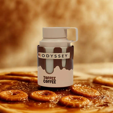 Odyssey Toffee Coffee mug with toffee cookies on a wooden surface