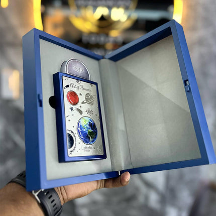 Blue box with a card featuring a colorful design held by a person.