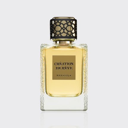 Perfume bottle labeled 'Creation de Reve' on a light gray background
