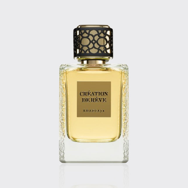 Perfume bottle labeled 'Creation de Reve' on a light gray background