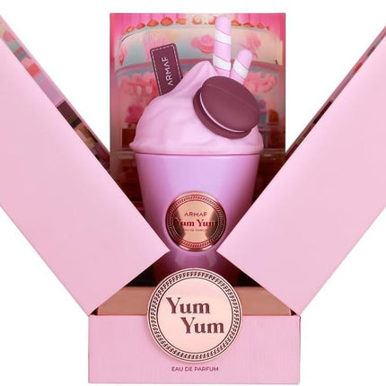 Pink 'Yum Yum' perfume bottle with packaging on a white background