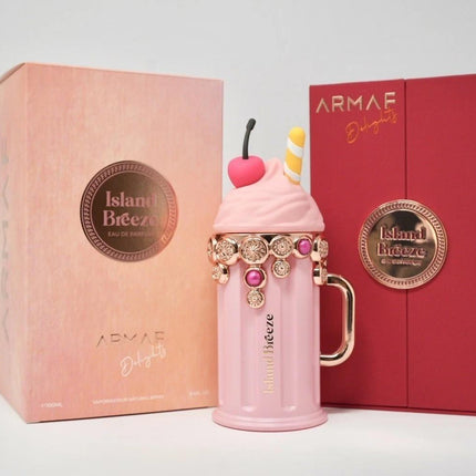 Pink milkshake-shaped bottle with decorative elements in front of two boxes, one pink and one red, featuring 'ARMAE' branding.