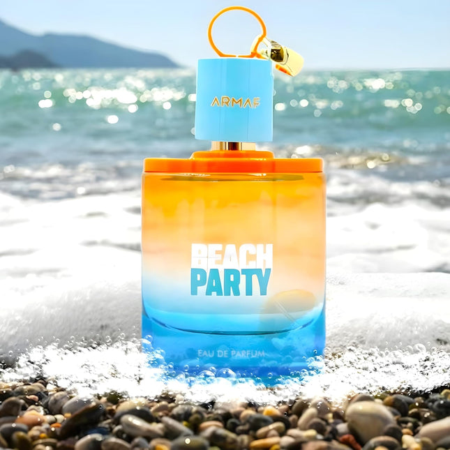 Perfume bottle labeled 'Beach Party' by Armaf on a beach with ocean in the background