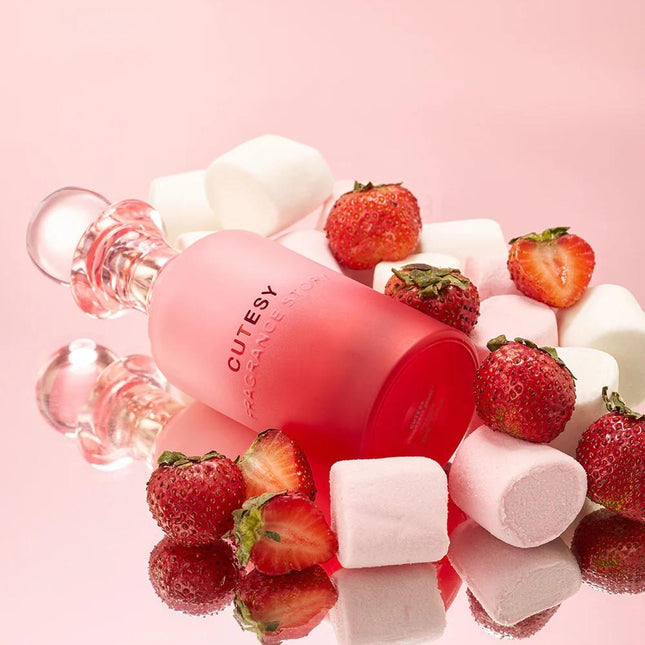 Pink lip balm with strawberries and marshmallows on a pink background